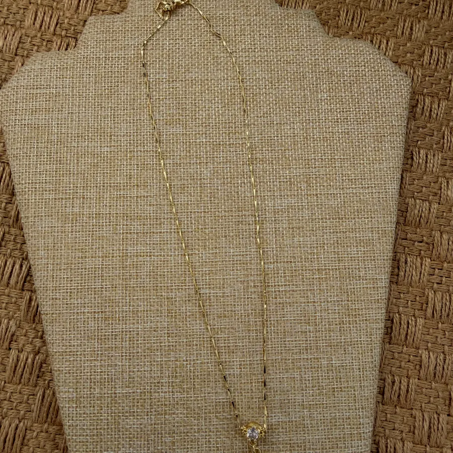 Necklace with a white flower and gold centre.