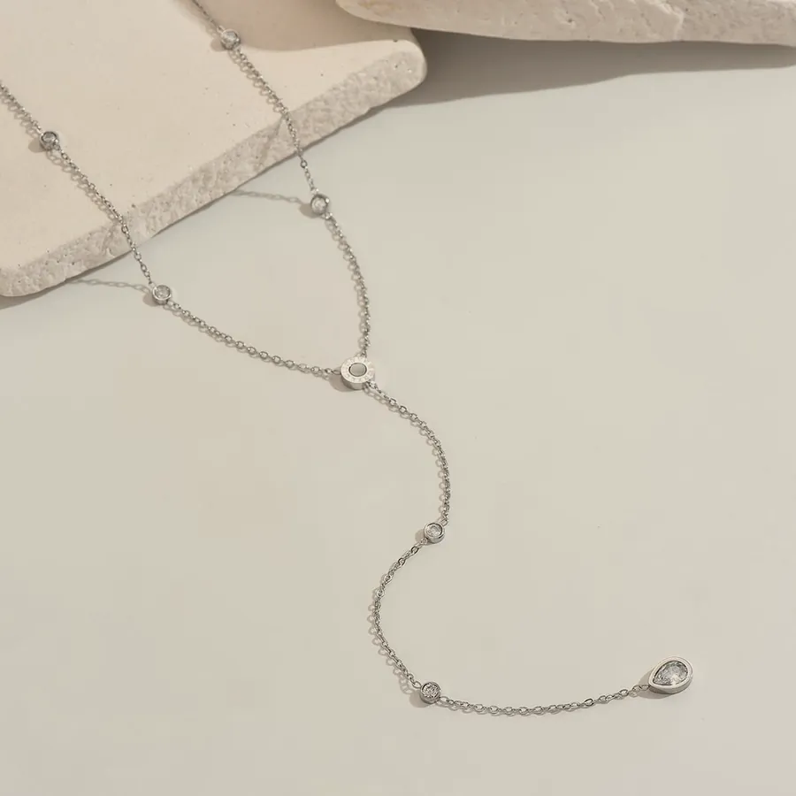 Silver lariat necklace with cubic zirconia.