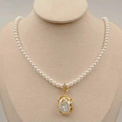 Pearl necklace with a gold medal.