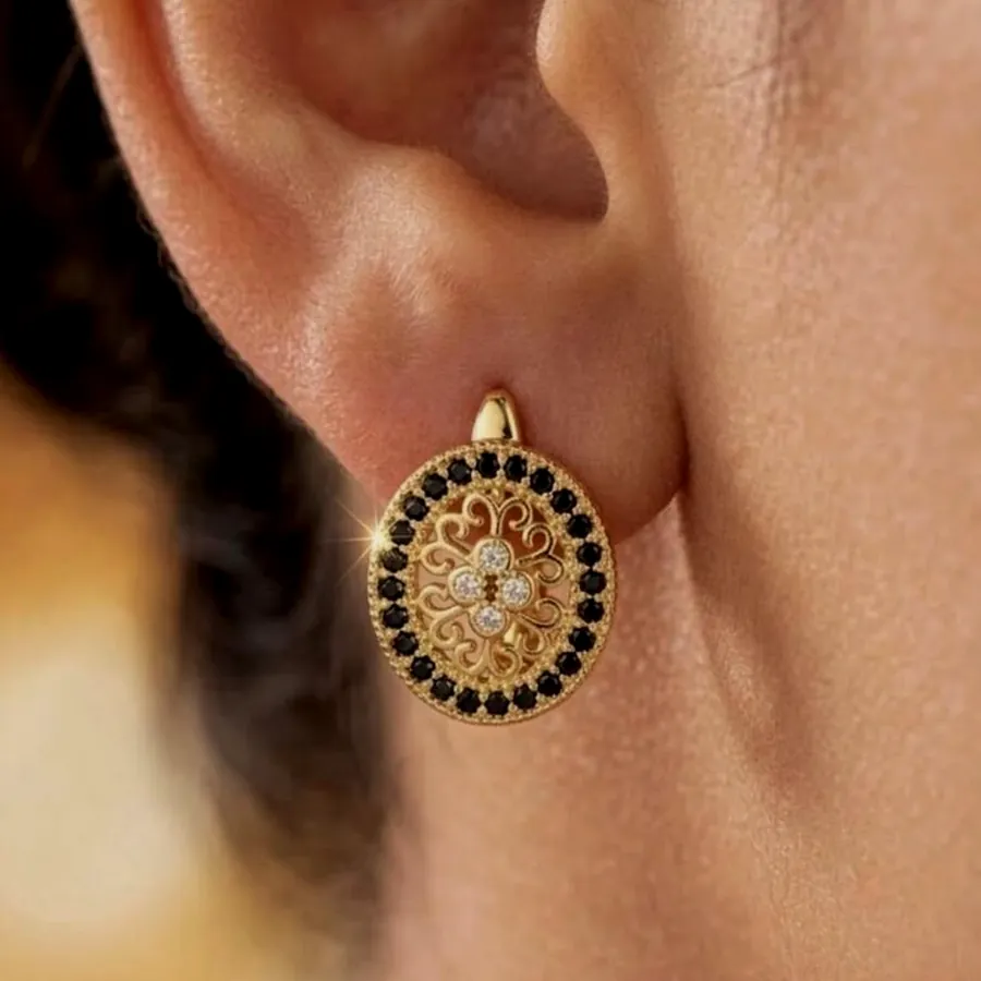 Black mosaic hoop worn on the ear.